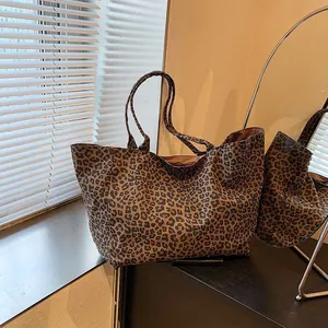 Macro view of large leopard print canvas tote bag in a cozy indoor window setting.