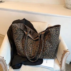 Stylish leopard print canvas tote bag shown in a cozy interior setting on an armchair