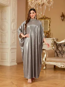 Detailed view of an elegant silver kaftan dress with rhinestone collar and batwing sleeves
