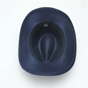Close-up detail of navy blue fedora hat interior with 57cm size label on the tag