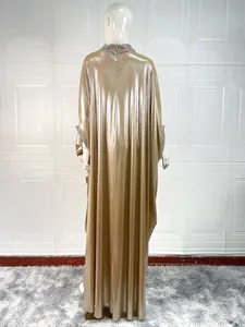 Back view of gold kaftan dress with rhinestone detailing on collar and cuffs