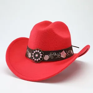Detailed close-up of a vibrant red wool felt cowboy hat with an embroidered floral band