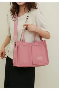 Bolso tote de lona rosa de gran capacidad con múltiples bolsillos y correa ancha ajustable
