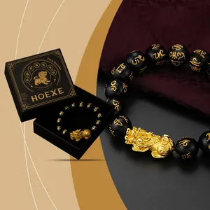 HOEXE Pixiu Armband mit goldgravierten schwarzen Perlen in luxuriöser Geschenkbox.