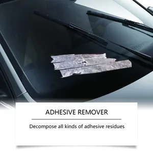 Demonstration of adhesive remover cleaning sticky residue on a car windshield.