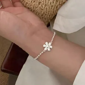 Elegant silver beaded bracelet featuring a dainty daisy flower charm for women