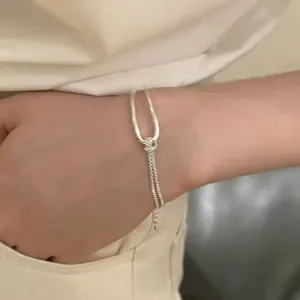 Minimalist silver geometric pull-through bracelet with adjustable chain for women.