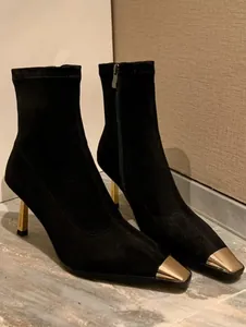 Black stretch ankle boots featuring gold metal square toe cap and thin high heel