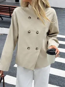 Close-up detail of an elegant beige double-breasted long-sleeve women jacket