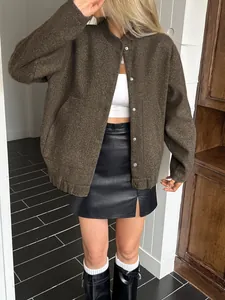 Stylish brown textured jacket paired with a black leather mini skirt for a chic look