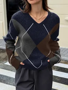 A detail view of a stylish color block argyle knit sweater with a classic V-neckline