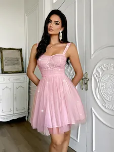 Elegant pink sequined mesh party dress featuring a bustier bodice and flared skirt.