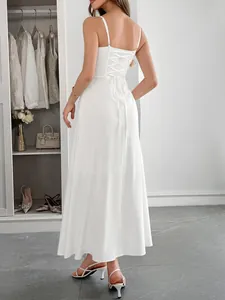 Close-up detail of the elegant lace-up back on a white summer spaghetti strap dress.