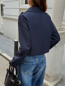 Back view of a navy blue long-sleeved casual jacket for women in an elegant street style.