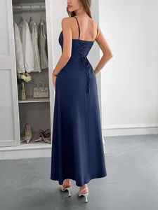 Detail view of a navy blue satin maxi dress featuring an elegant lace-up back design.