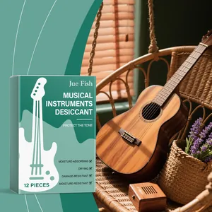 Desecante para instrumentos musicales Jue Fish junto a una guitarra acústica de madera.