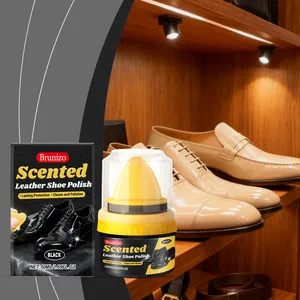 Detail view of Brunizo black leather shoe polish with application sponge and polished shoes