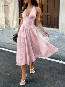 Close-up detail of a pink jacquard halter dress featuring a deep V-neck for summer vacation