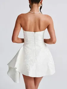 Elegant back view of a white jacquard strapless mini dress with side ruffle and zipper