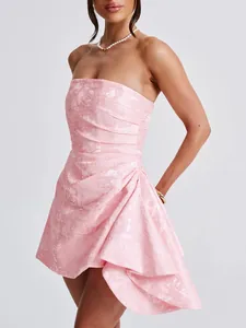 Detail of a pink strapless French style floral jacquard mini dress with ruffles