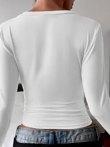 Close-up view showing the back detail of a white slim-fit long-sleeve T-shirt for women