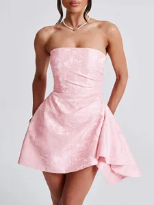 Close-up detail of a pink strapless French style jacquard mini dress with ruffled hem