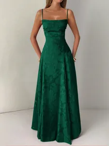 Detailed view of emerald green strap evening dress with elegant floral patterns