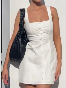 Detail of a white square neck sleeveless button-down mini dress with slim fit design.