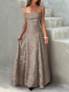 Detail of elegant taupe floral jacquard maxi dress with square neckline and straps.