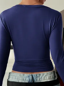 Back view detail of an elegant navy blue slim-fit long-sleeve T-shirt for women