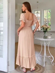Elegant peach ruffled short sleeve maxi dress showing a stylish open back design for summer