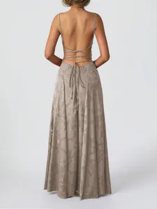 Detailed back view of an elegant floral resort maxi dress featuring a backless lace-up design