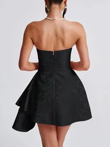 Detail back view of a black strapless jacquard dress with ruffled hem and hidden zipper