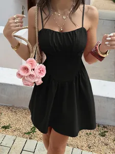 Detail view of a black French vacation cami dress with a ruched bust and fitted waistline