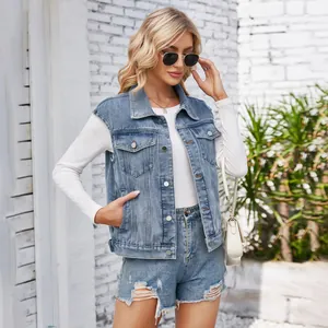 Close-up detail of a women's washed classic denim vest paired with ripped denim shorts