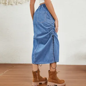 Detailed side view of washed blue denim midi skirt with adjustable drawstring and elastic waist.