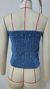 Vista posteriore dettagliata di un elegante top a tubo in denim arricciato blu su un manichino.