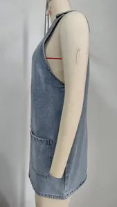 Detailed side view of a stylish blue washed denim overall dress shown on a mannequin