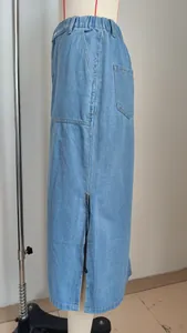 Close-up of light blue denim midi skirt featuring side drawstring and slit detail