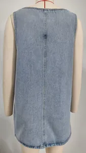 Back view detail of a washed light blue denim pinafore midi dress on mannequin