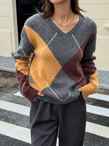 Detail of a chic argyle color-block V-neck knit sweater in grey, yellow, and burgundy