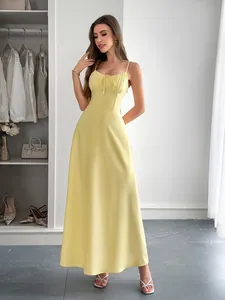 Detailed view of elegant pale yellow spaghetti strap maxi dress for summer vacation