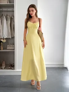 Elegant pale yellow spaghetti strap maxi dress with ruched bust and flared A-line skirt