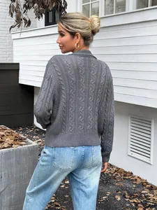 Close-up detail of the grey cable-knit pattern on the back of this chic women sweater