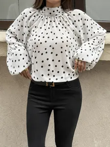 Elegant white blouse featuring black polka dots, high neck, and chic puff sleeves detail.