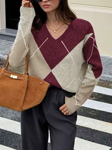 Detail view of a stylish V-neck argyle color-block knitted sweater for autumn
