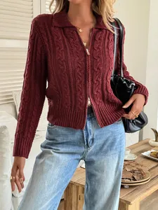 Close-up of a burgundy cable-knit zip-up cardigan showing knit texture and collar.