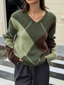 Close-up detail of a green and brown argyle patterned V-neck knit sweater on a model