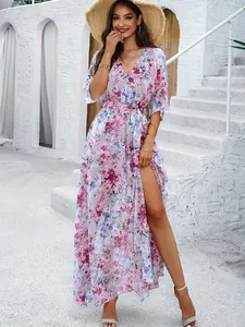 Close-up detail of the elegant floral print and side slit on this boho maxi dress.