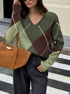 Close-up of women's v-neck color block argyle knit sweater in retro green and brown